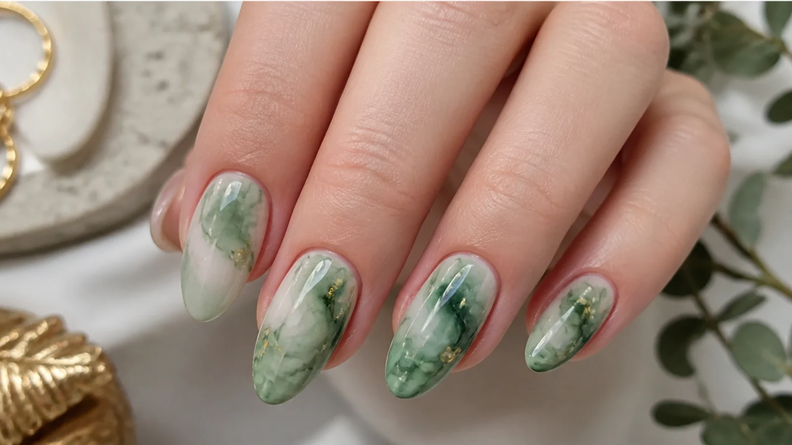 Sage-to-emerald green blooming gel nails with a soft watercolor bloom on almond nails