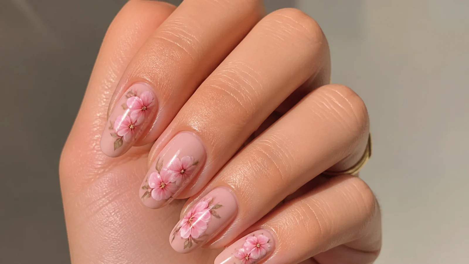 Pink blooming gel nails with clear negative space around the bloom