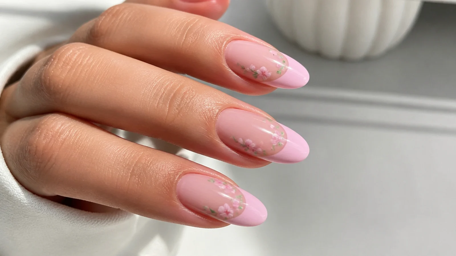 Pink blooming gel nails mixing a soft French with small floral accents