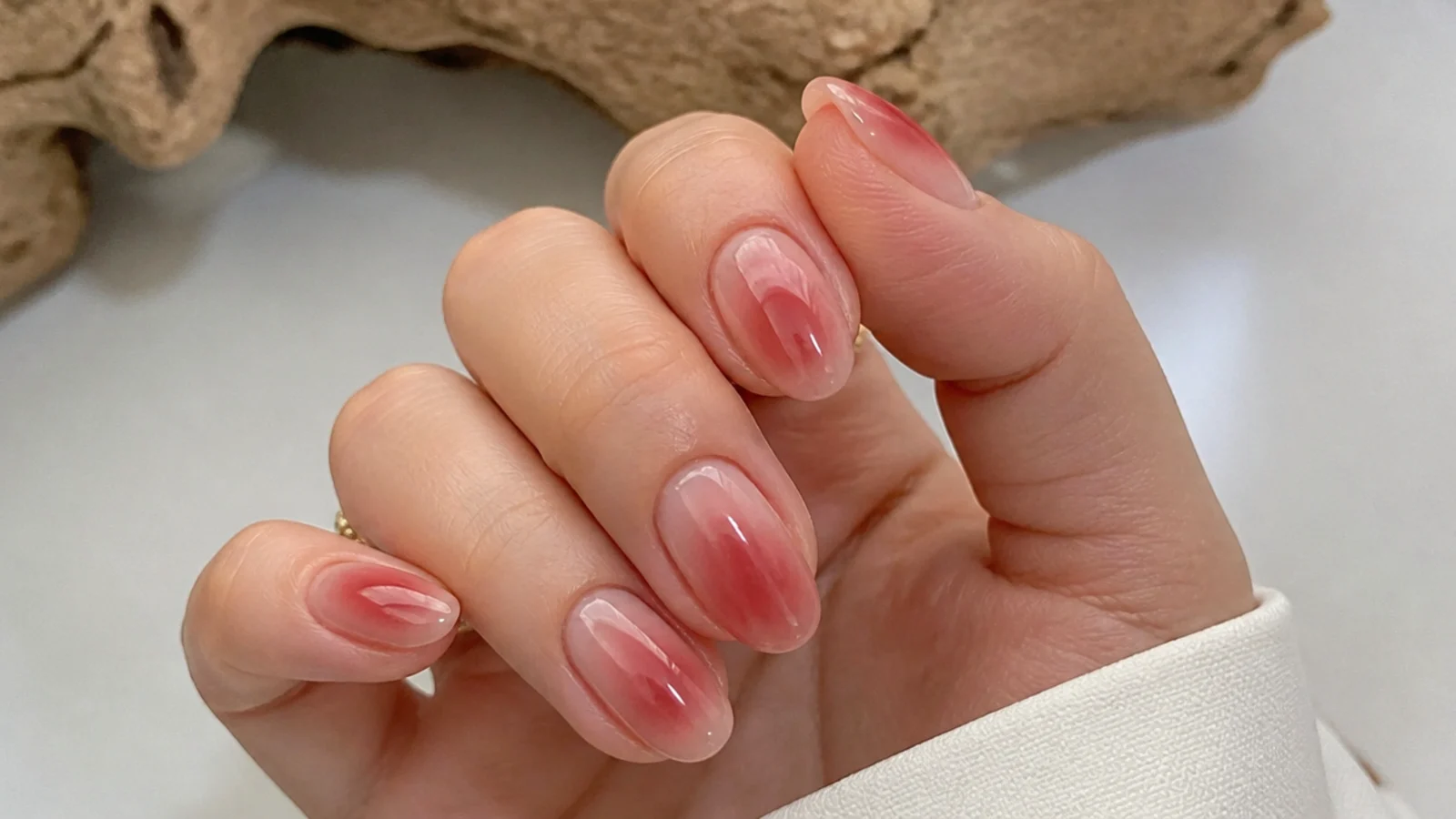 Soft red cloud gradient blooming gel nails fading from tip to base