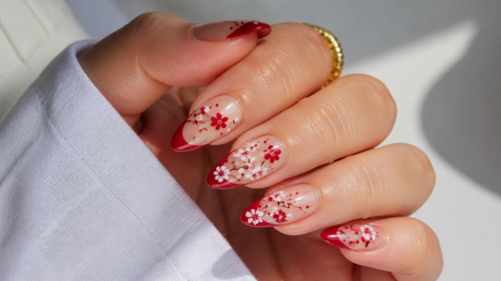 Red and white cherry blossom design on blooming gel nails