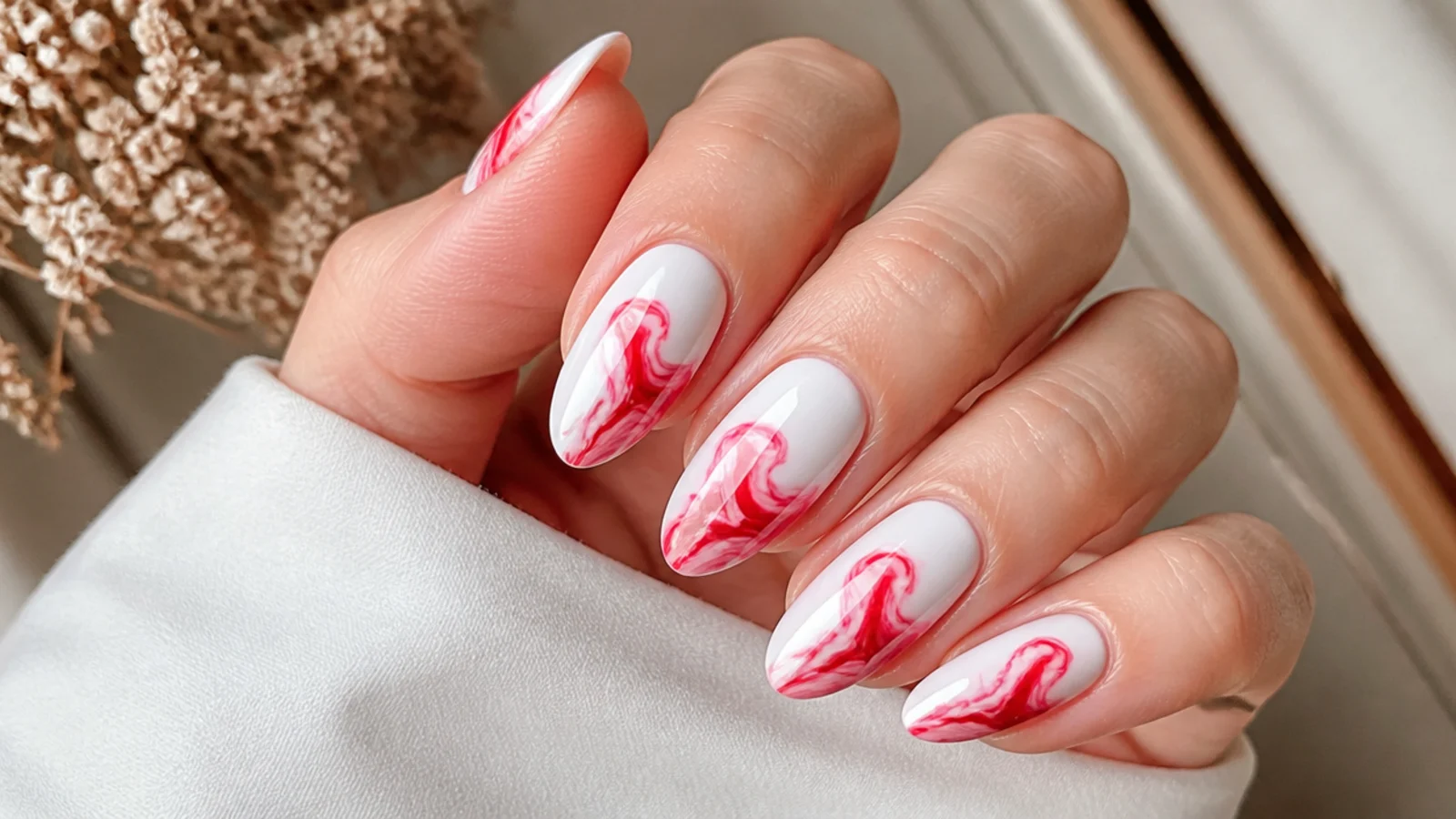 Scarlet abstract swirls blooming across white blooming gel nails