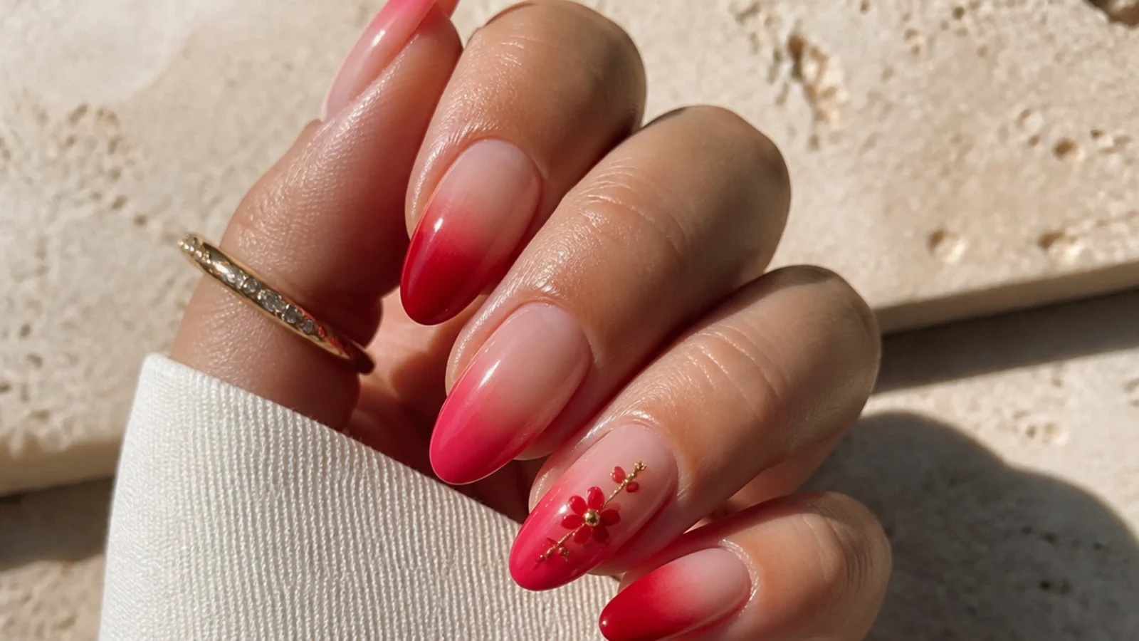Red blooming gel French tip that diffuses into a nude base