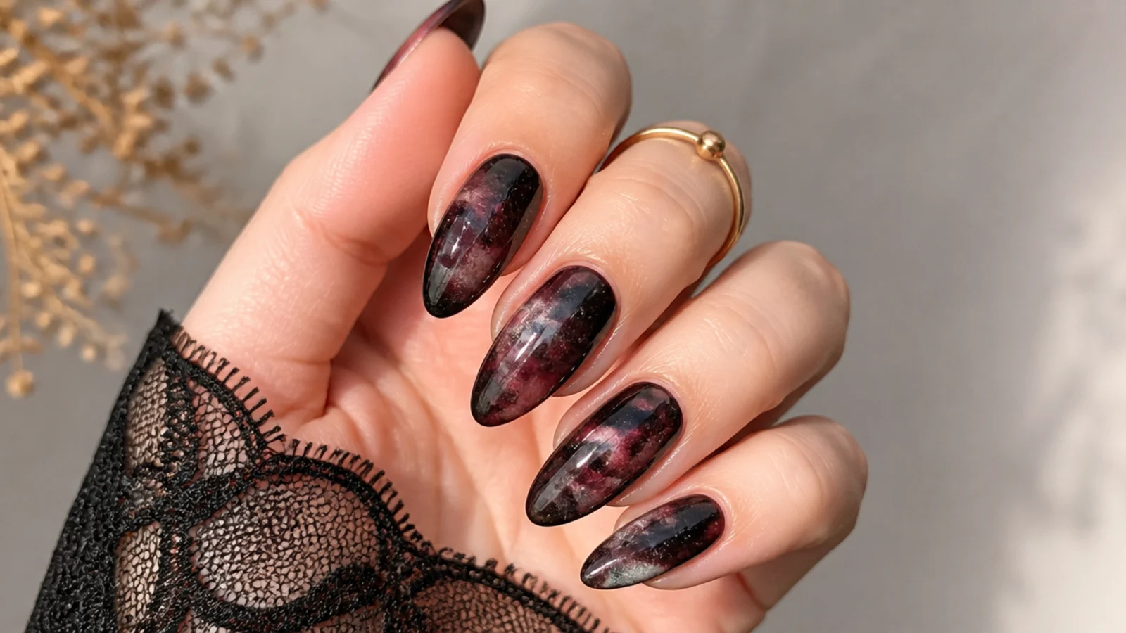 Deep red and black galaxy ink blooming gel nails with speckled depth