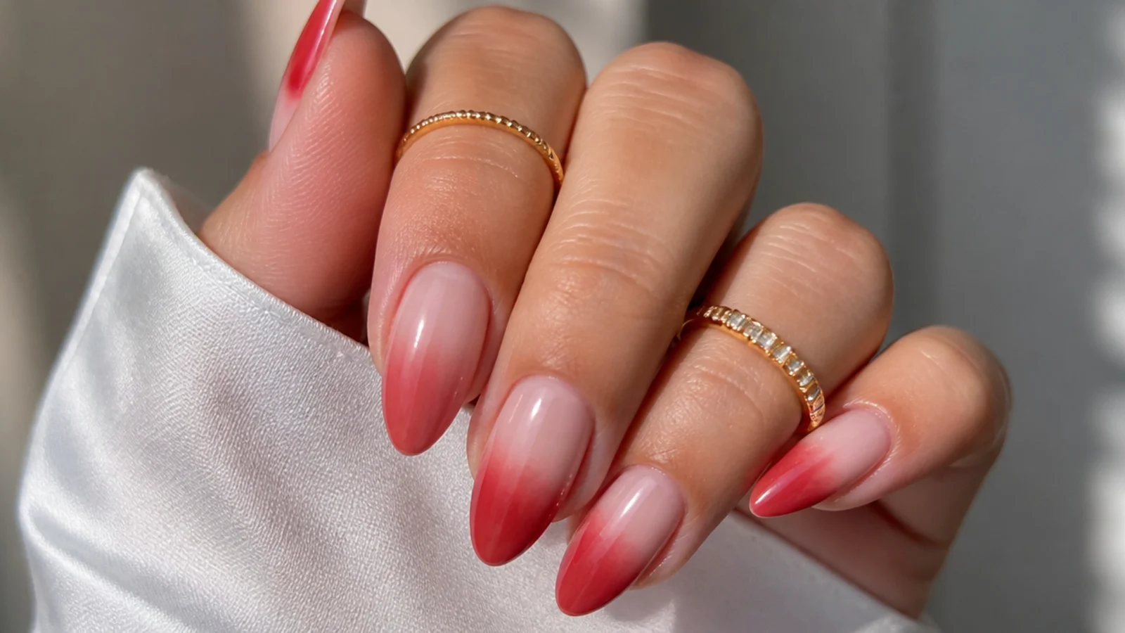Red ombre blooming gel nails fading light to deep across the set