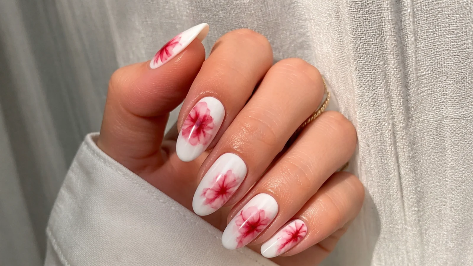 Abstract red ink blob shapes blooming on white gel nails
