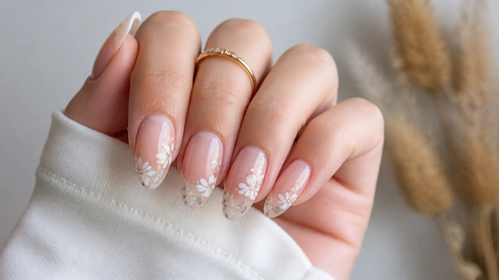 Soft white blooms over a nude base blooming gel nails