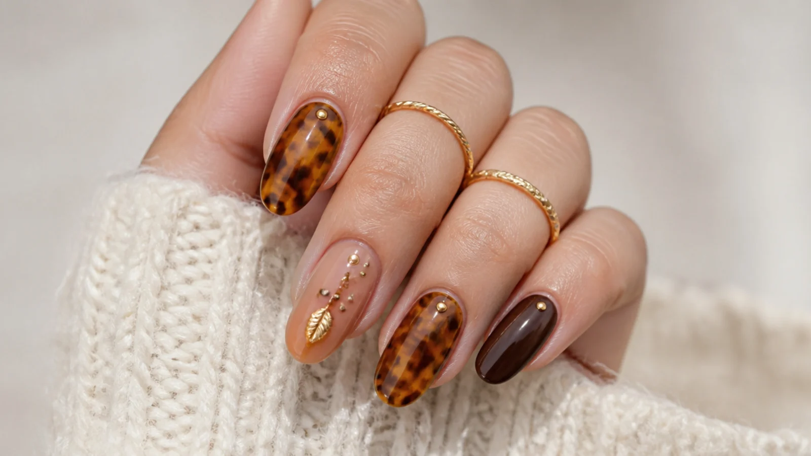 Warm brown and amber tortoiseshell boho nails on oval shapes