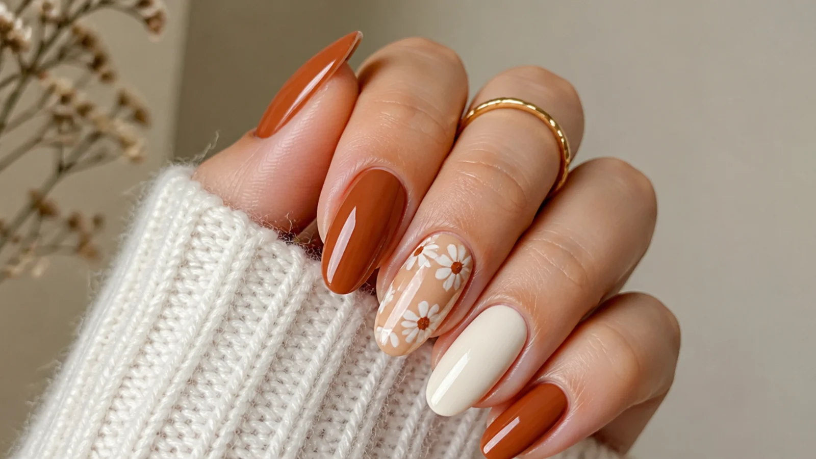 Burnt orange boho fall nails with a small cream daisy accent