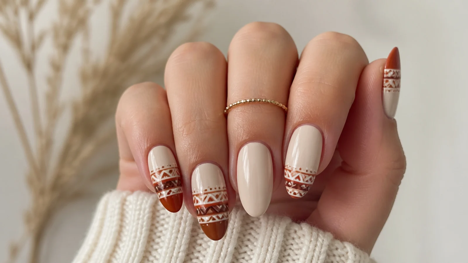 Cream boho fall nails with rust and brown aztec pattern tips