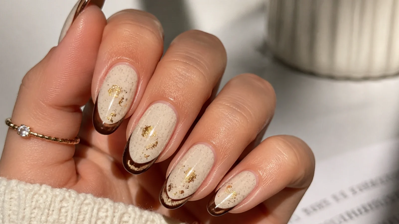 Cream boho fall nails with chocolate brown tips and muted gold flakes