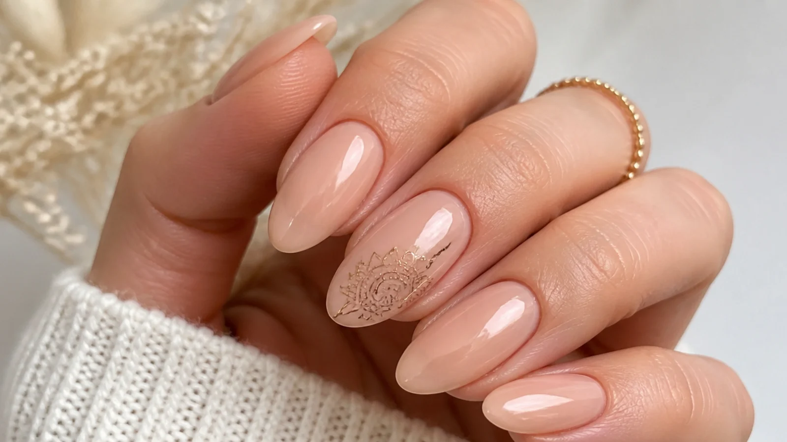 Nude nails with fine muted-gold mandala line work on one accent nail