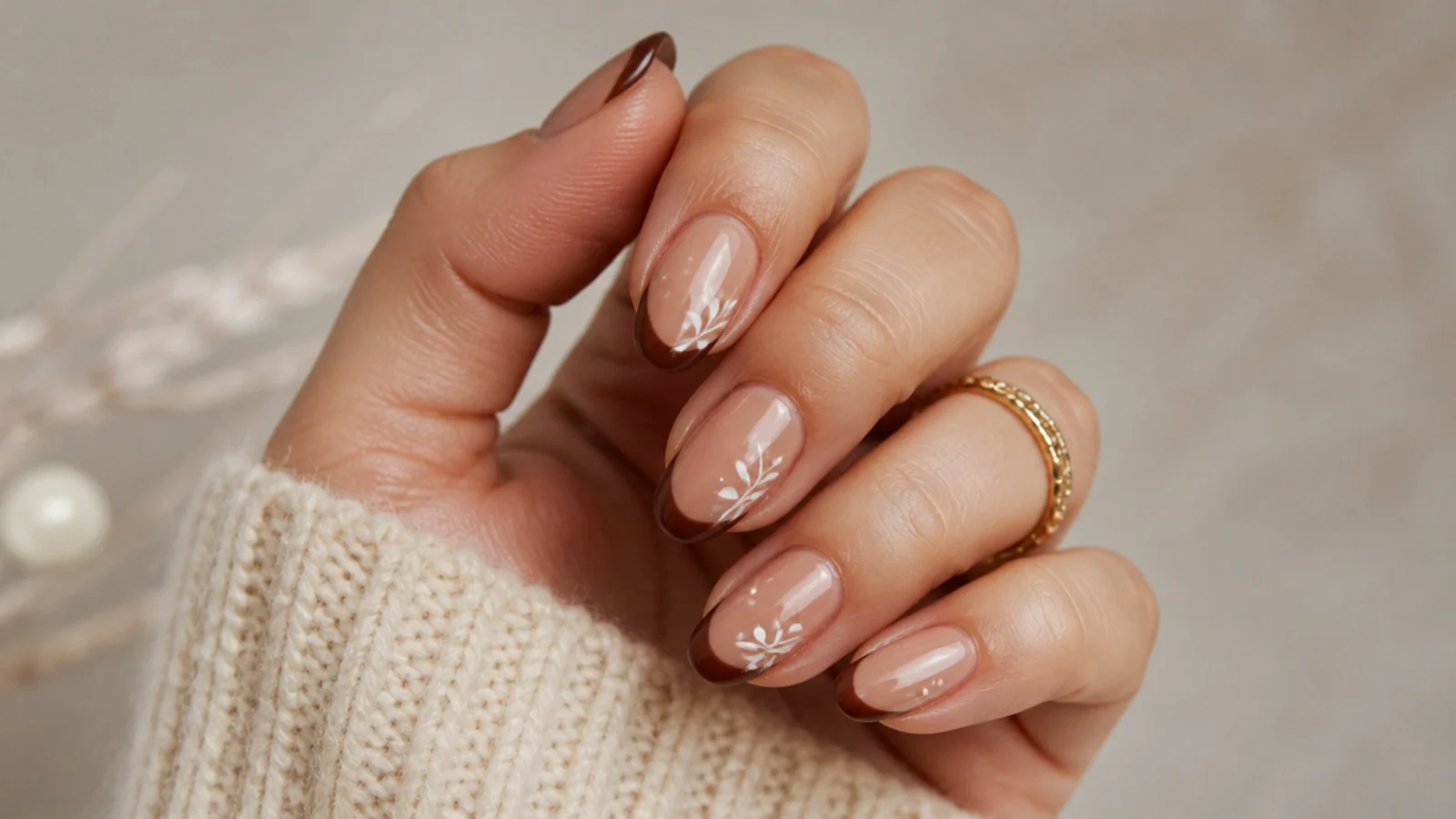 Nude boho nails with an earthy cocoa brown French tip