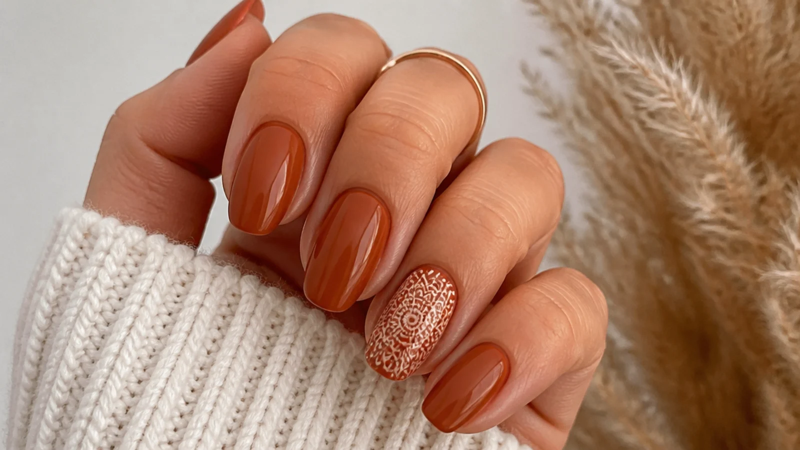 Rust boho nails with a fine cream mandala on one accent nail