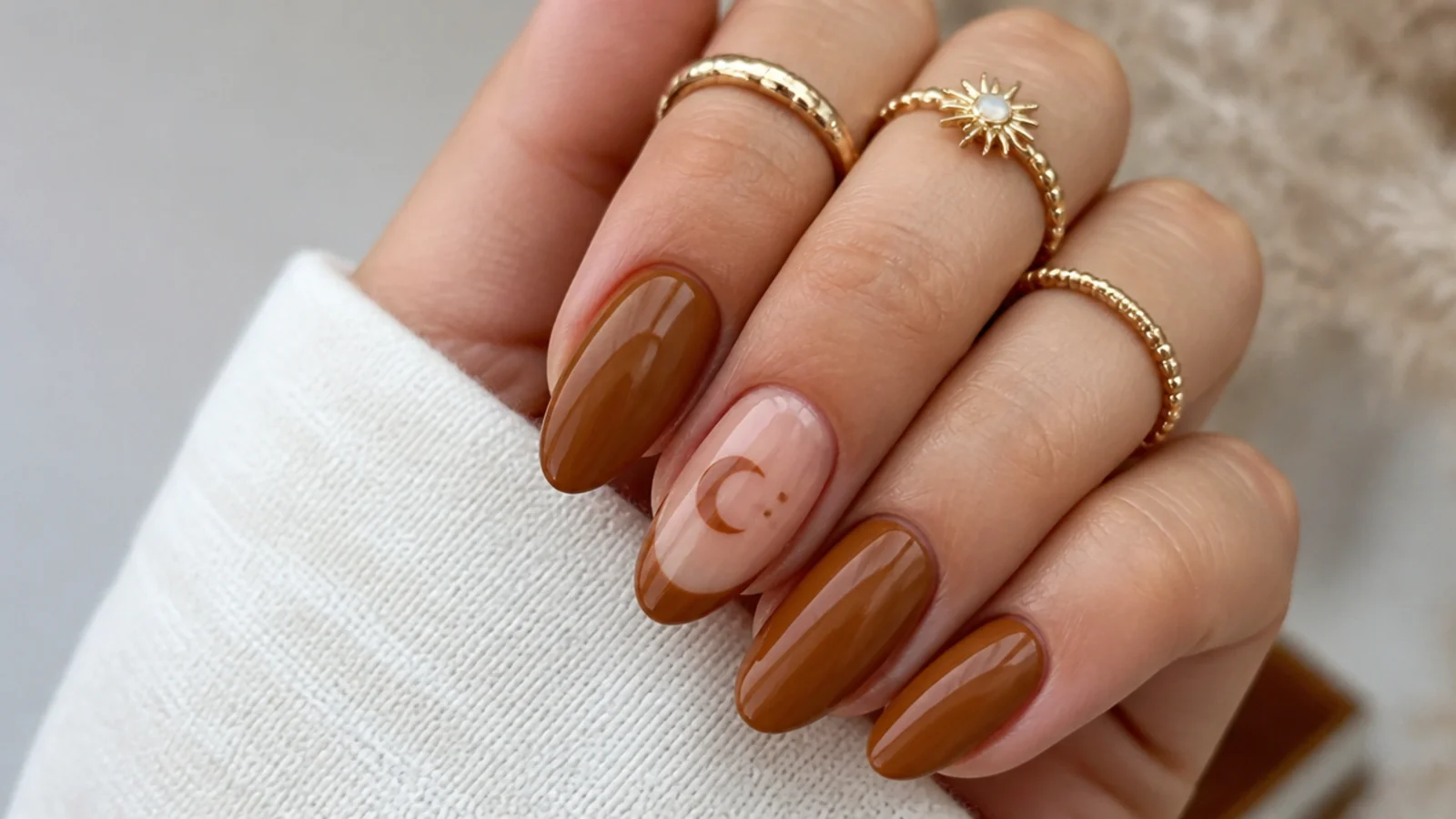 Tan boho nails with a negative-space crescent moon on a natural nail
