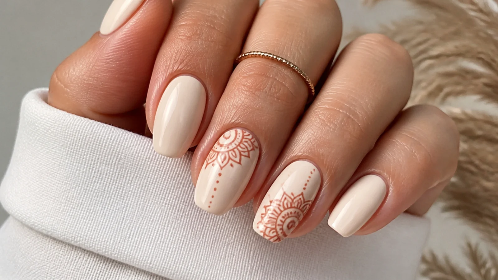 Cream boho nails with a fine terracotta mandala accent