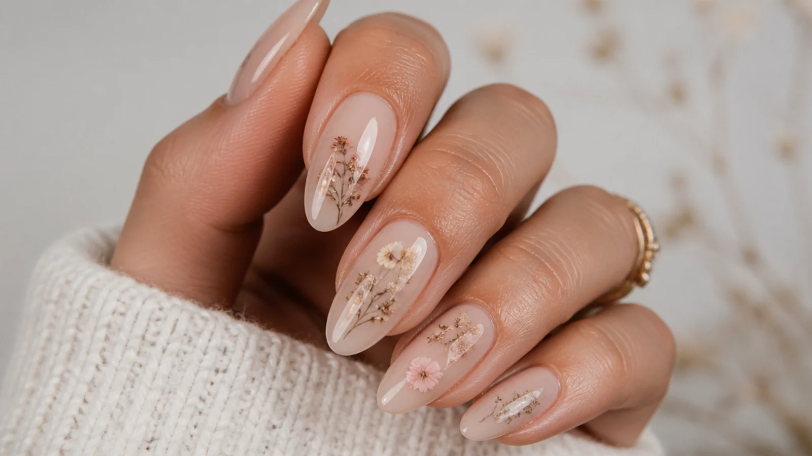 Nude boho nails with pressed-flower style dried florals