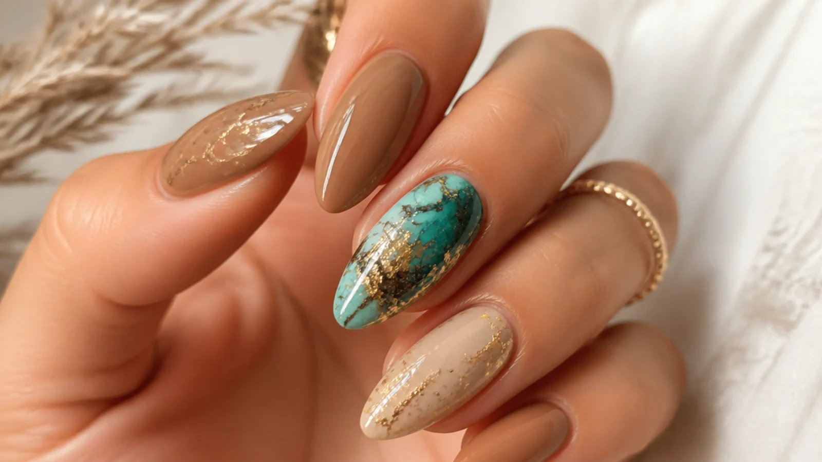 Tan boho nails with a turquoise stone marble accent and gold flecks