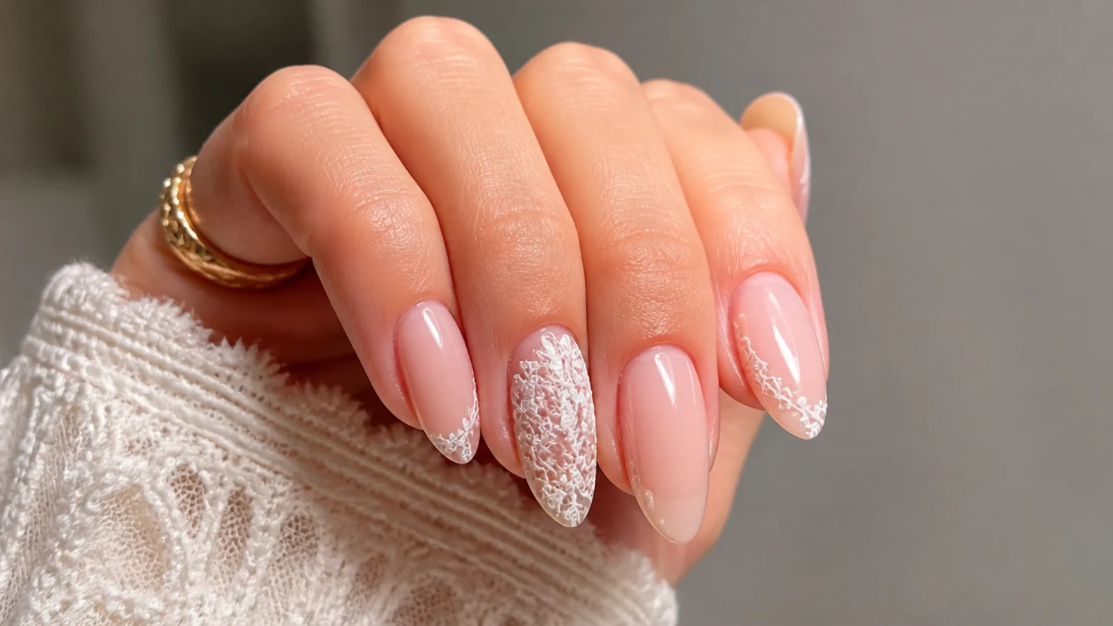 Soft nude boho bridal nails with delicate white lace detail