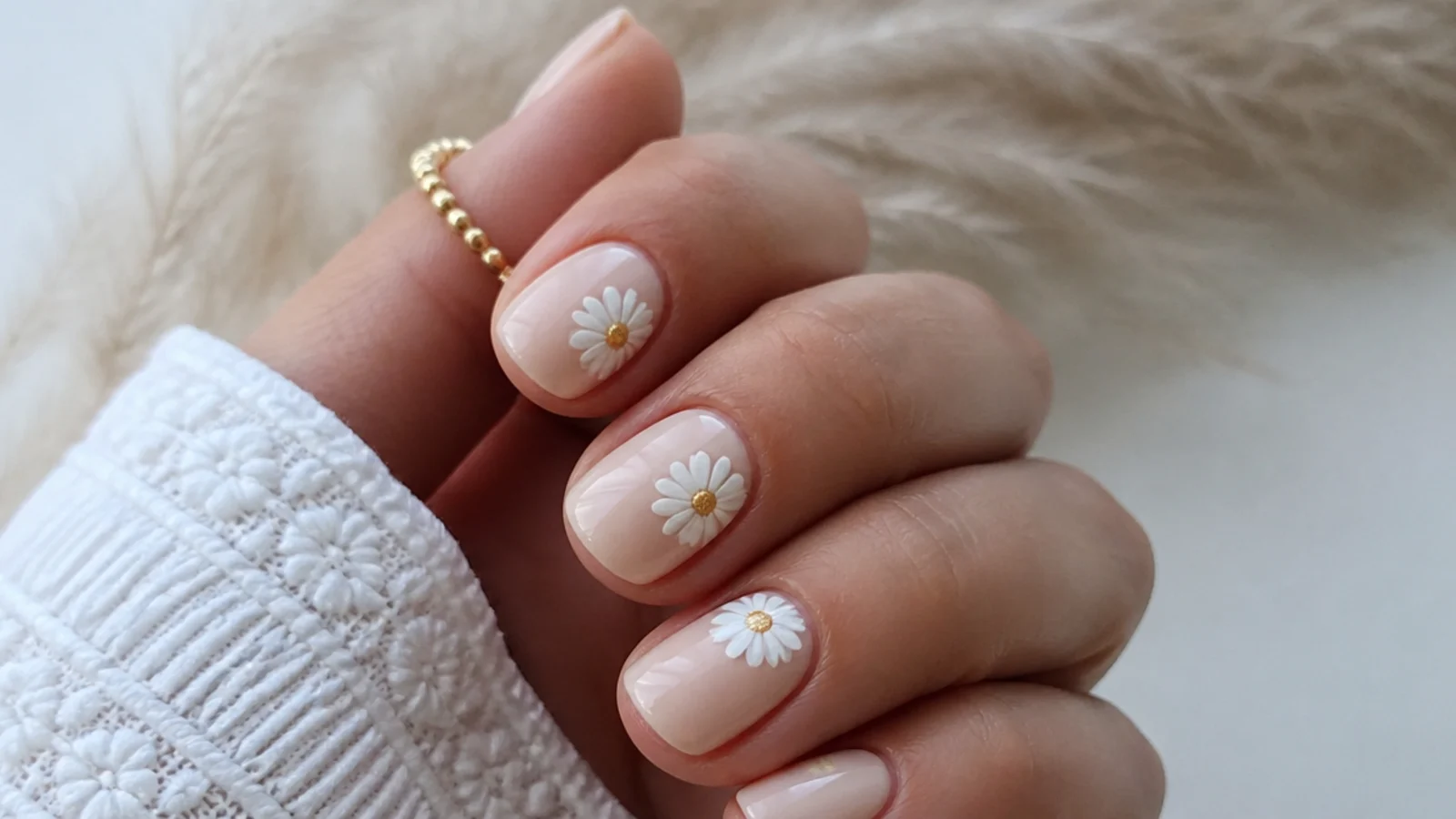 Cream boho spring nails with small white daisies and gold centers on short nails