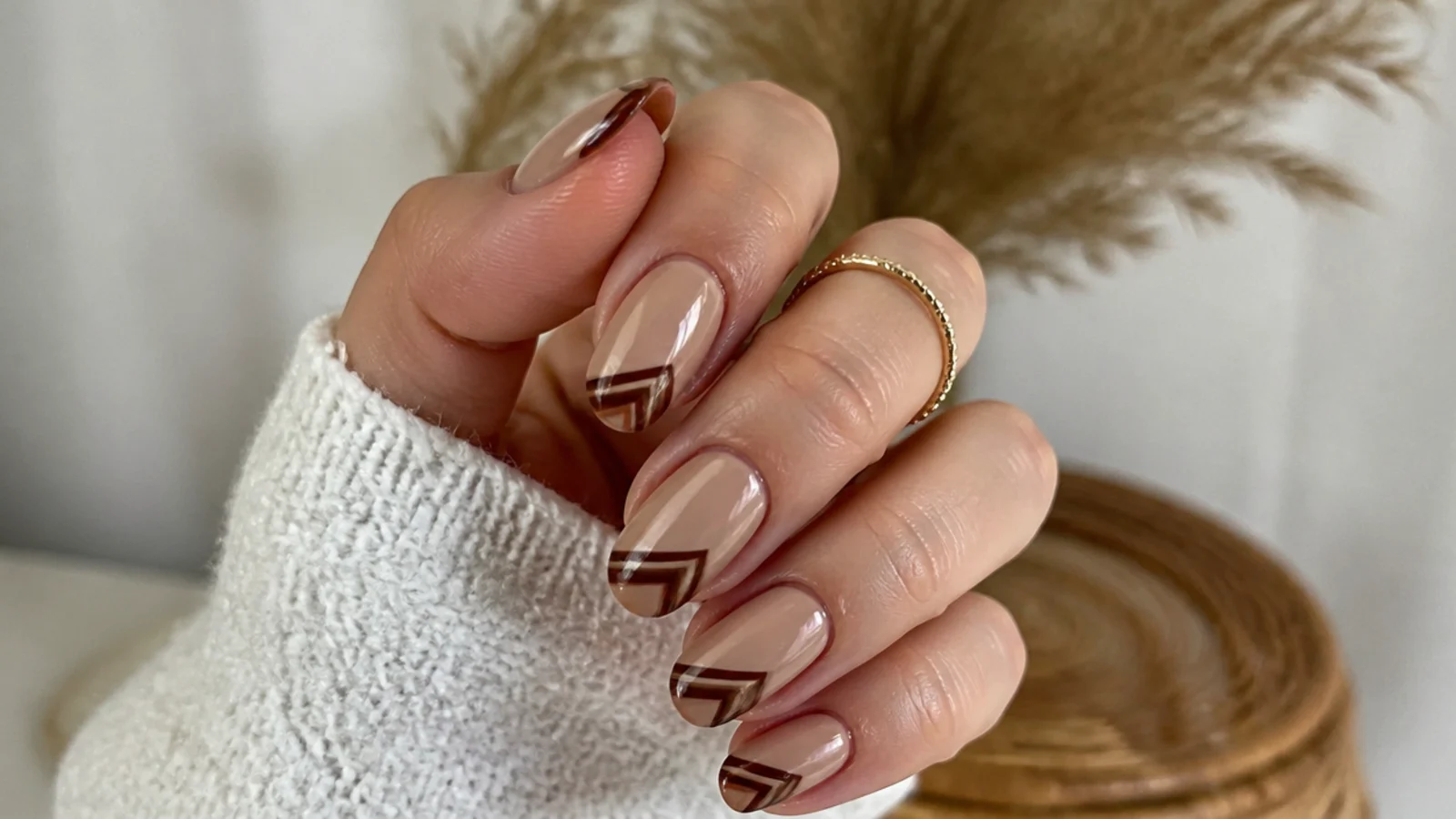 Tan boho spring nails with brown geometric aztec line tips on almond nails