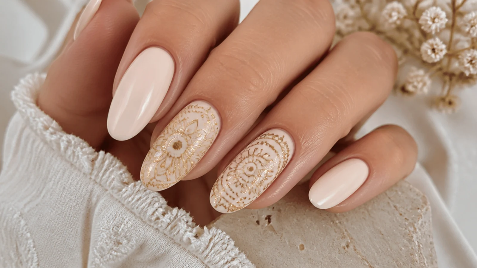 Cream boho wedding nails with fine gold mandala detail on the accent nails