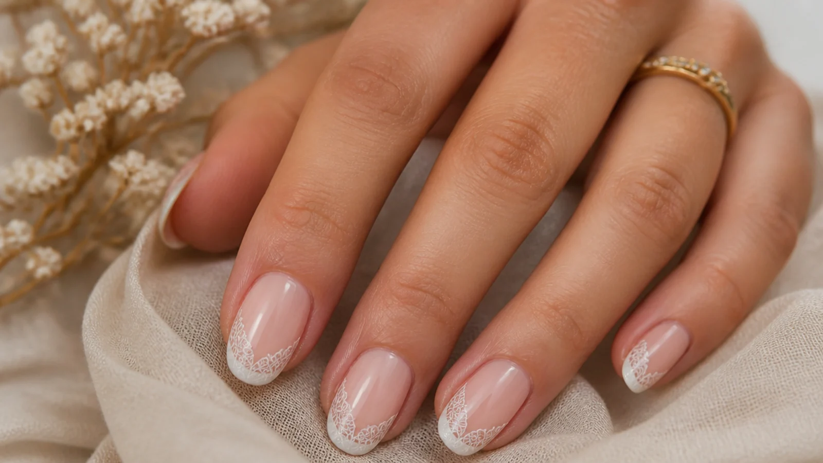 Soft nude boho wedding nails with a fine white lace-tip French detail