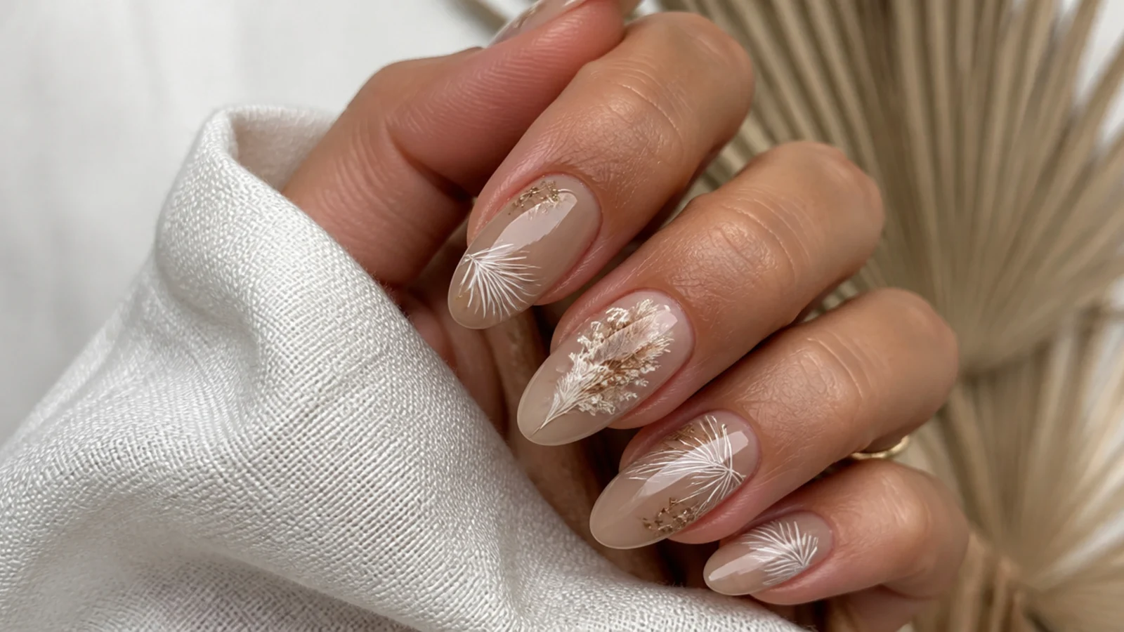 Tan boho wedding nails with fine cream pampas and dried palm line art