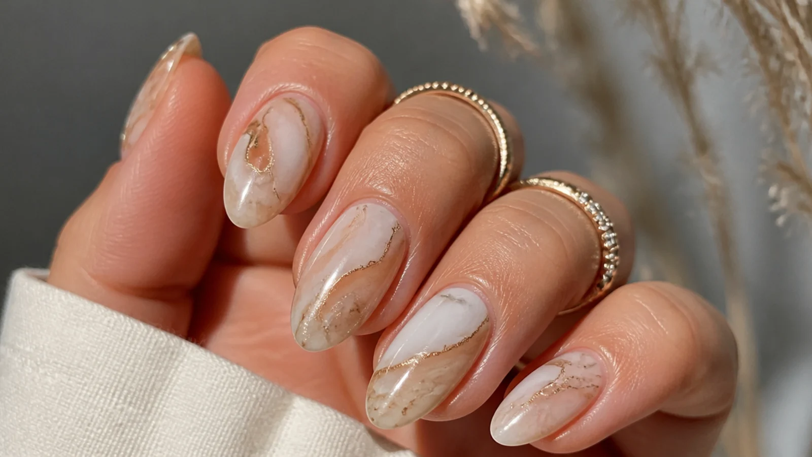 Cream boho wedding nails with soft tan and gold marble swirls