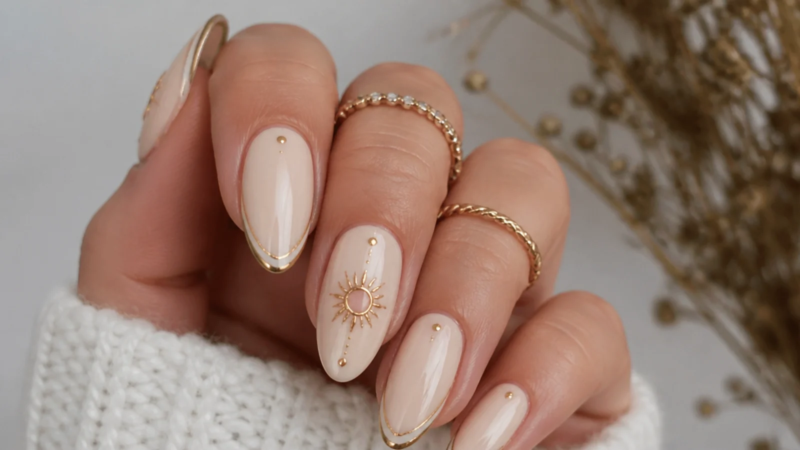 Cream boho wedding nails with a fine muted gold sun motif accent nail