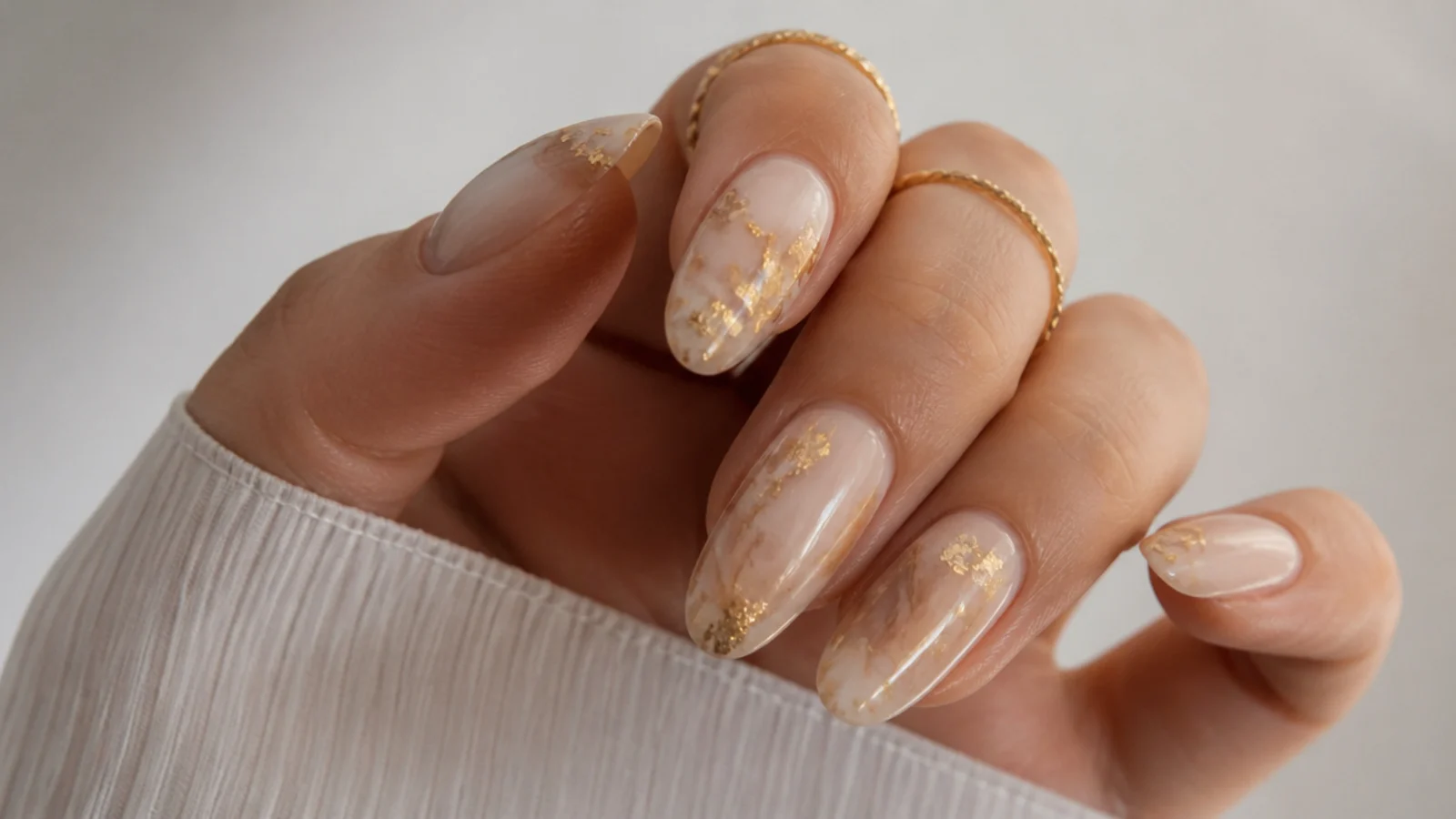 Milky tan boho wedding nails with torn gold foil flakes