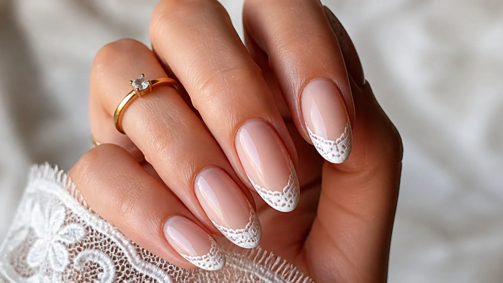 Sheer nude boho wedding nails with fine white lace-detail French tips