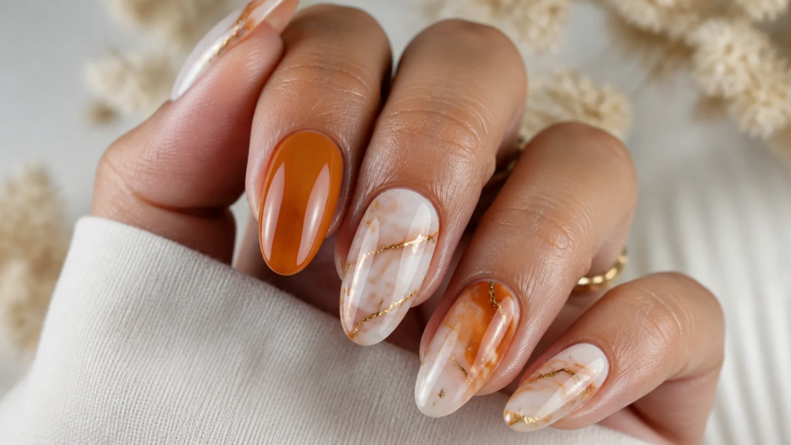 Burnt orange and cream marble boho wedding nails with soft veining