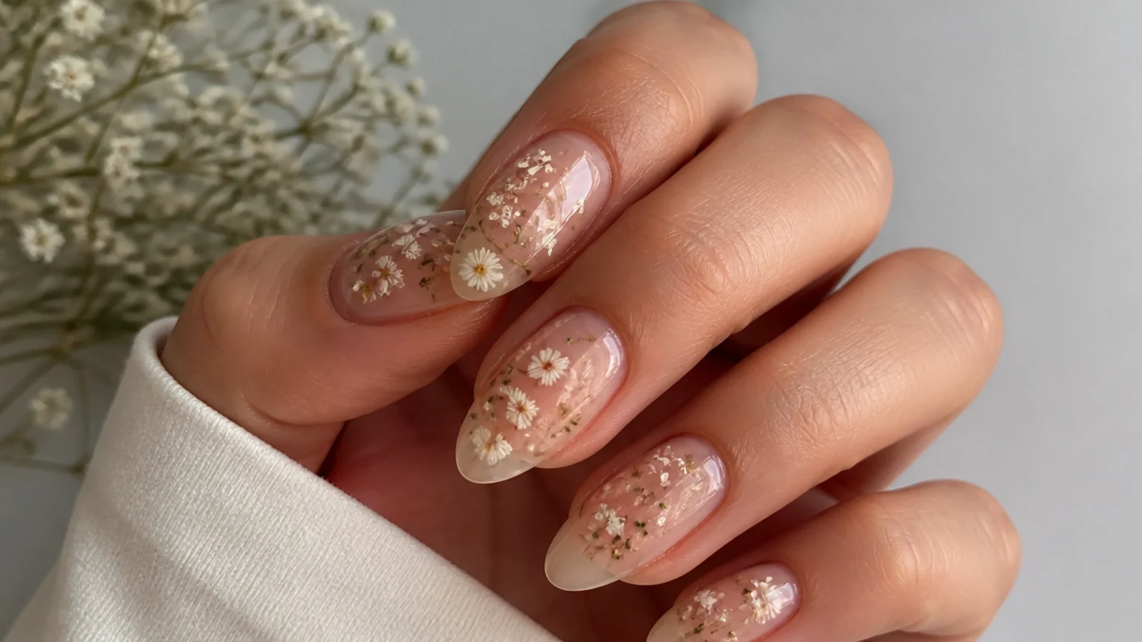 Sheer boho wedding nails with real dried micro-flowers encapsulated under gel