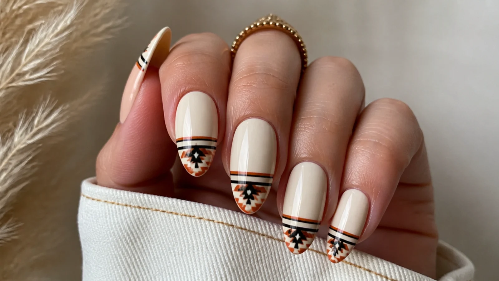 Cream boho western nails with geometric aztec stripe tips in rust and black