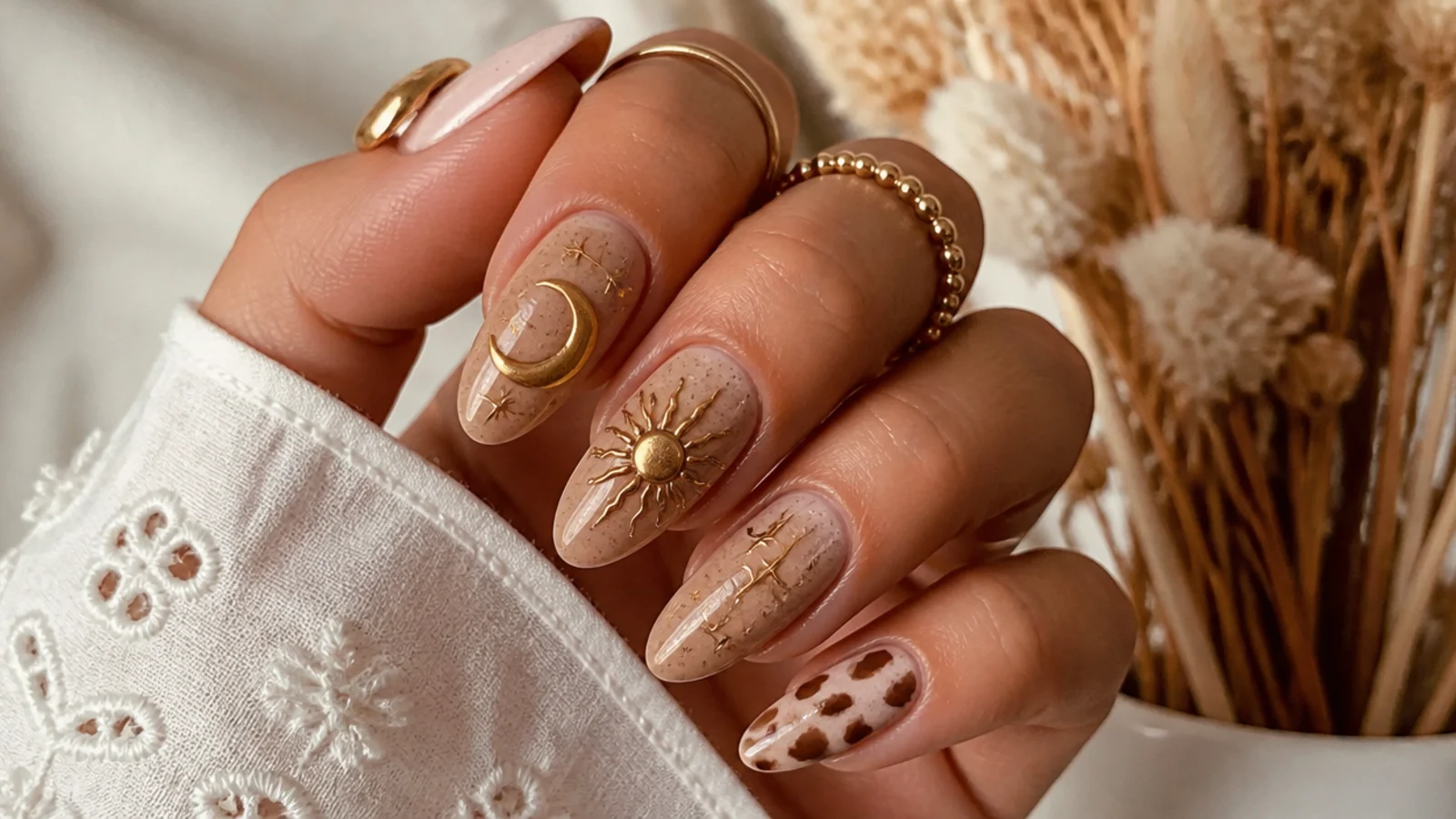 Gold sun and moon motifs on tan boho western nails
