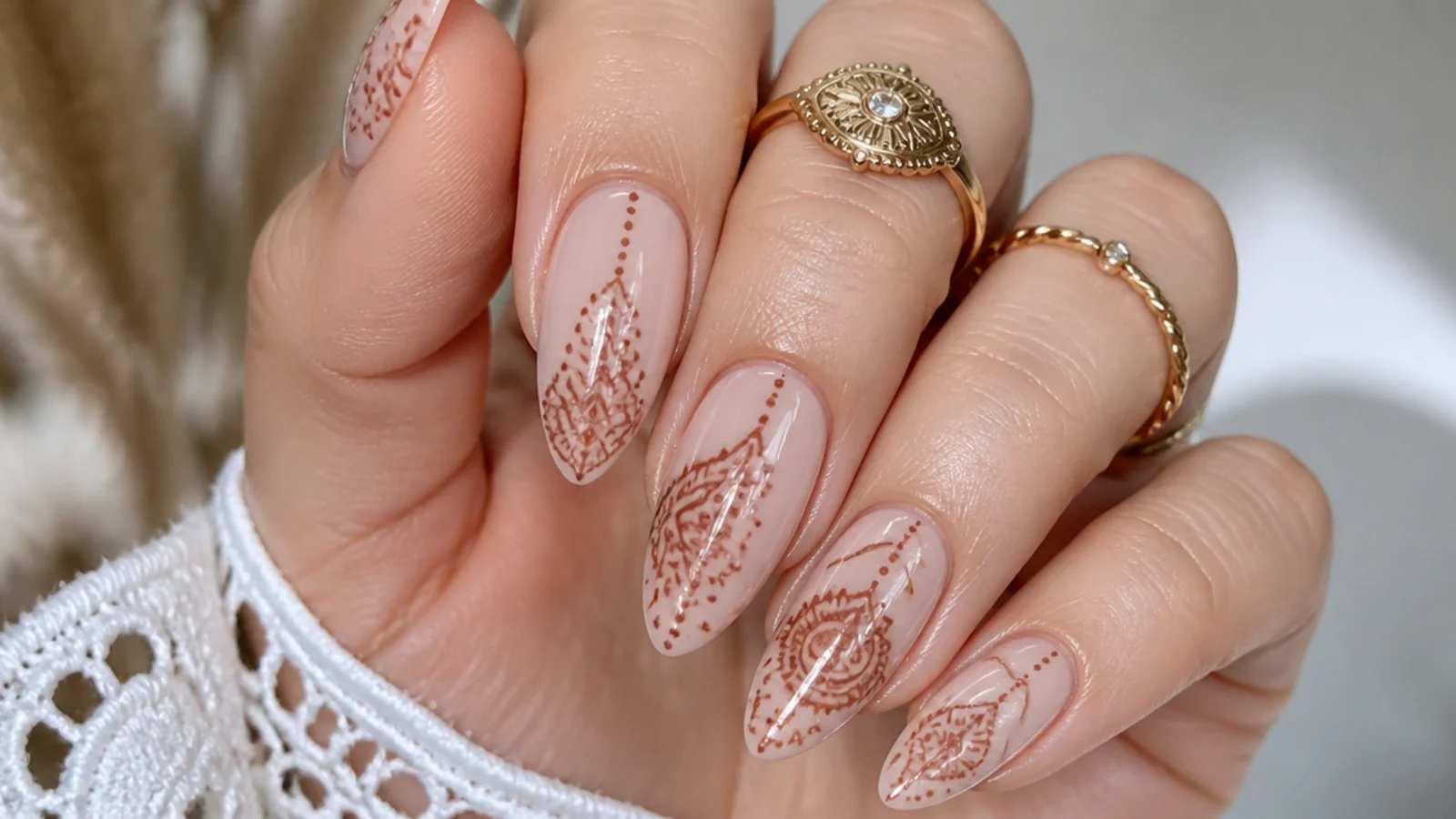 Henna-style fine-line boho nails with paisley and dots on nude