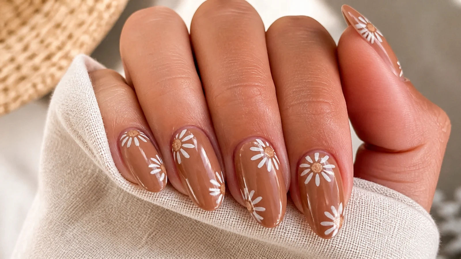 Tan boho nails with small white daisies and muted gold centers
