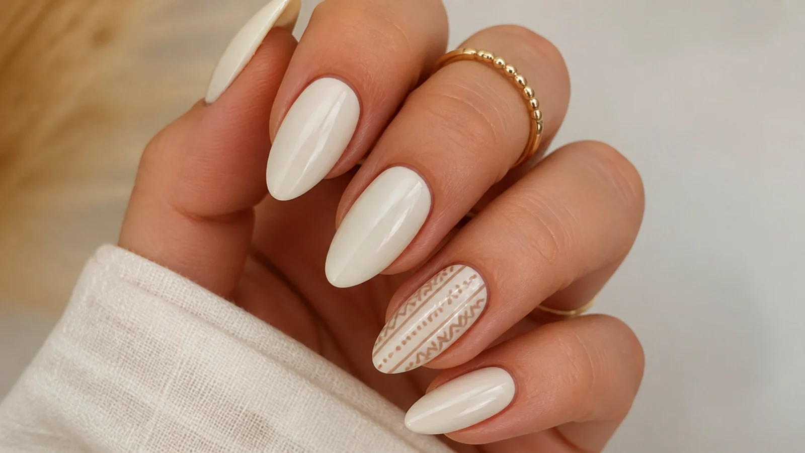 Cream boho nails with a small brown aztec line pattern on one accent nail