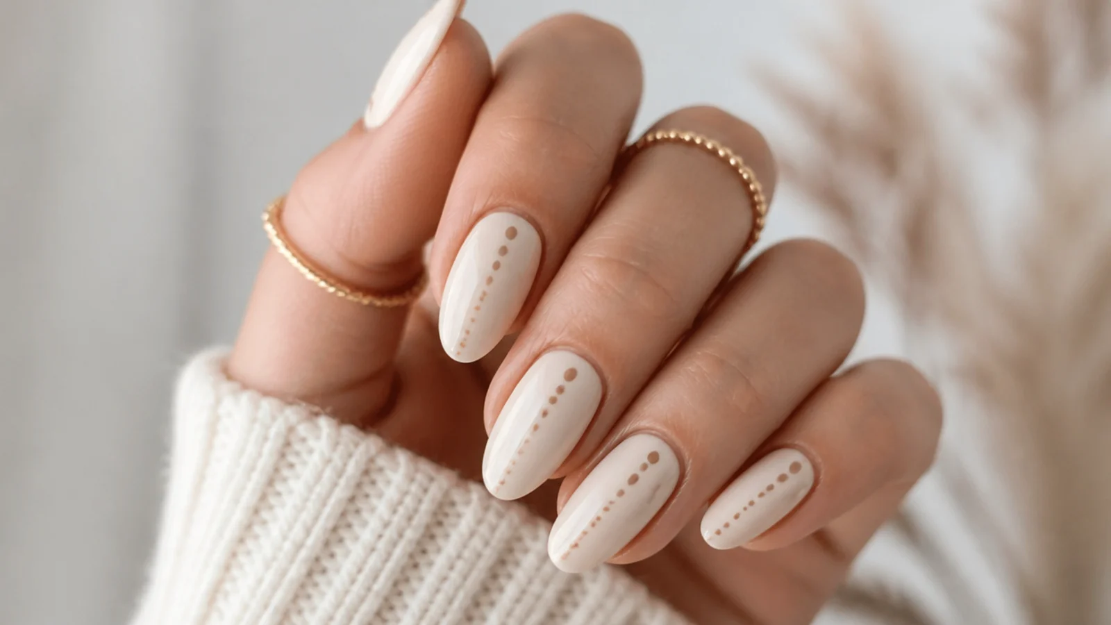 Cream boho nails with a simple trail of small brown dots on each nail