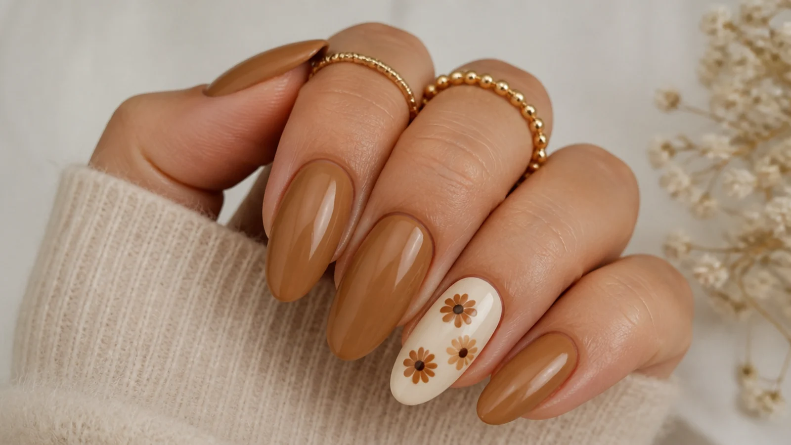 Tan boho nails with small cream and brown daisies on the accent nail