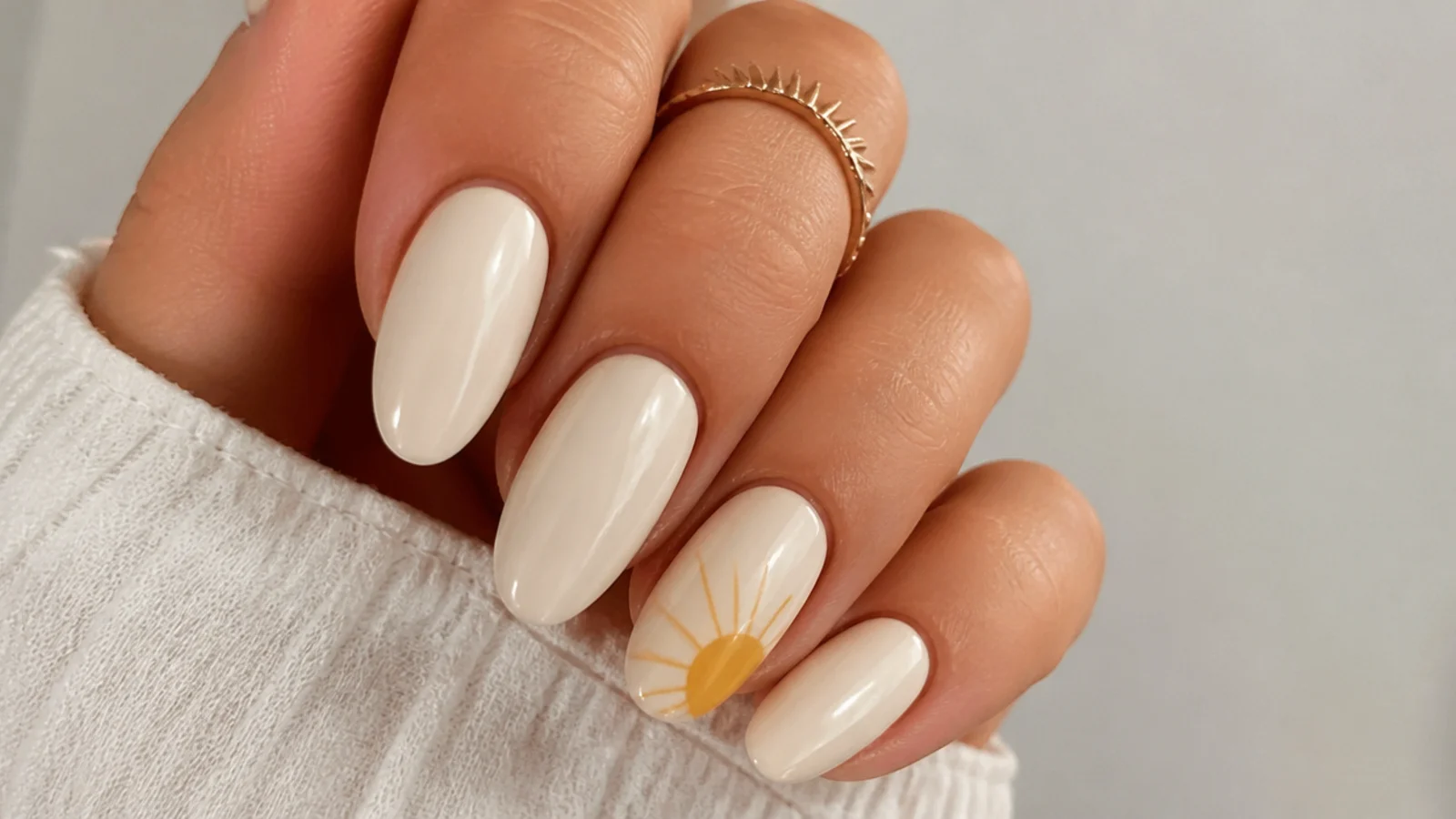 Cream boho nails with a mustard yellow sun and rays on the accent nail