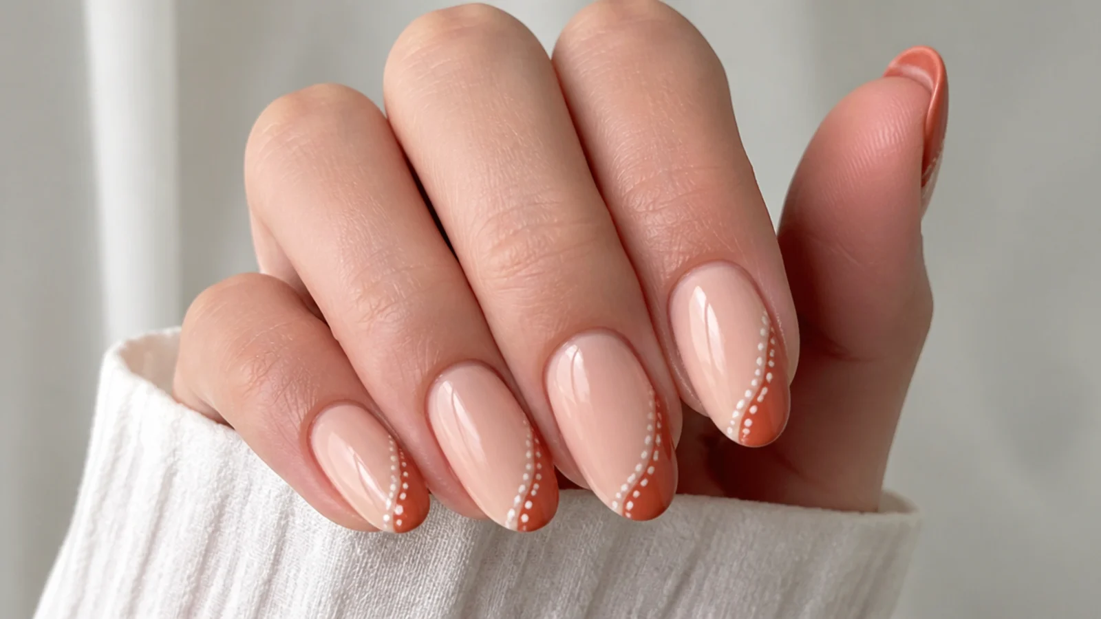 Nude boho nails with freehand burnt orange tips