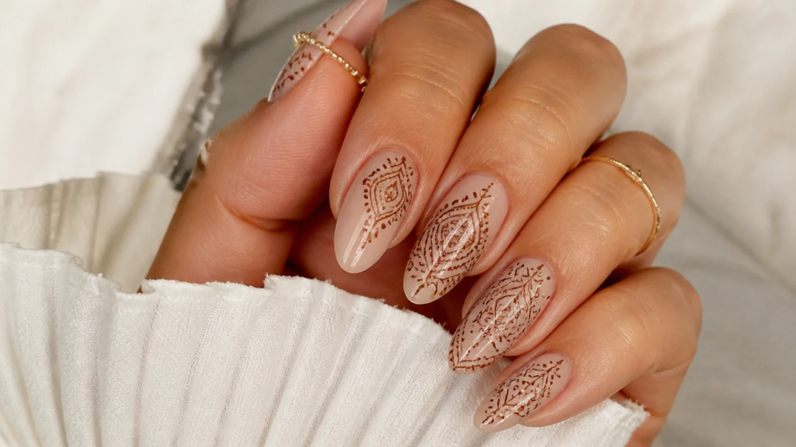 Nude boho nails with fine brown henna-style paisley line work