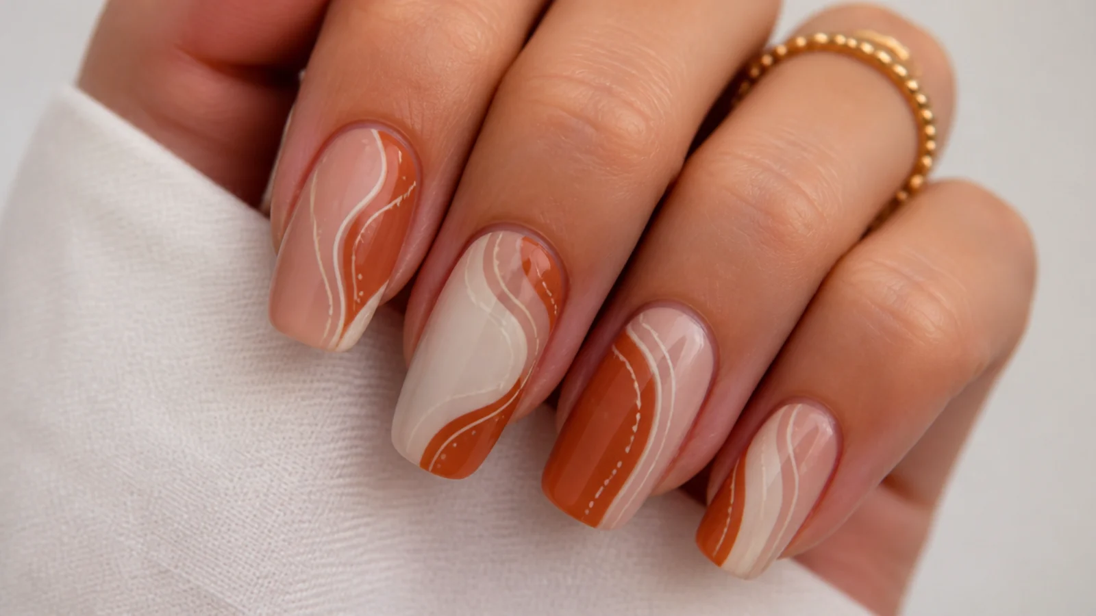 Abstract rust and cream boho nails with hand-painted organic lines