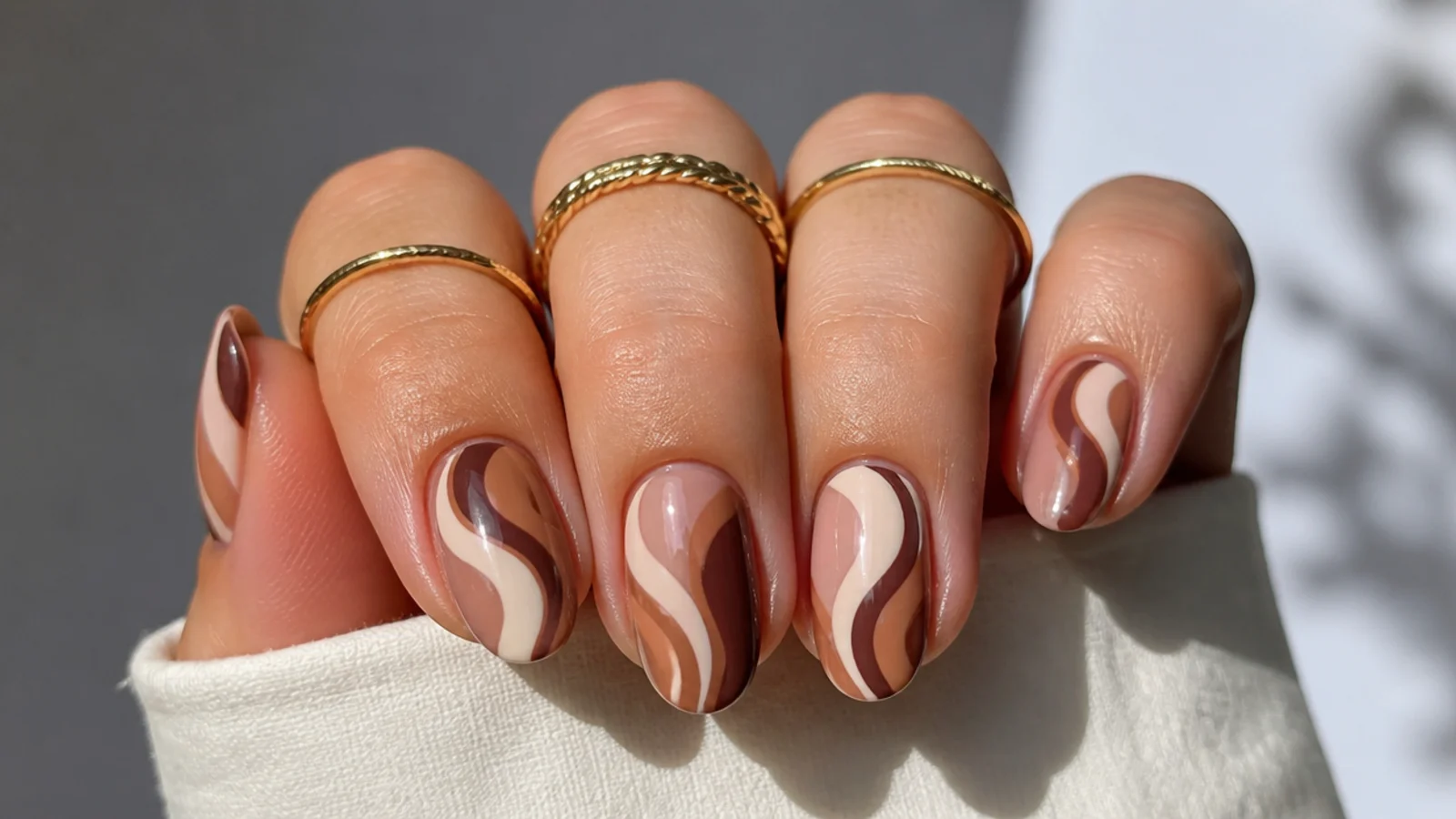 Boho retro swirl nails in tan, brown and cream on short almond shape