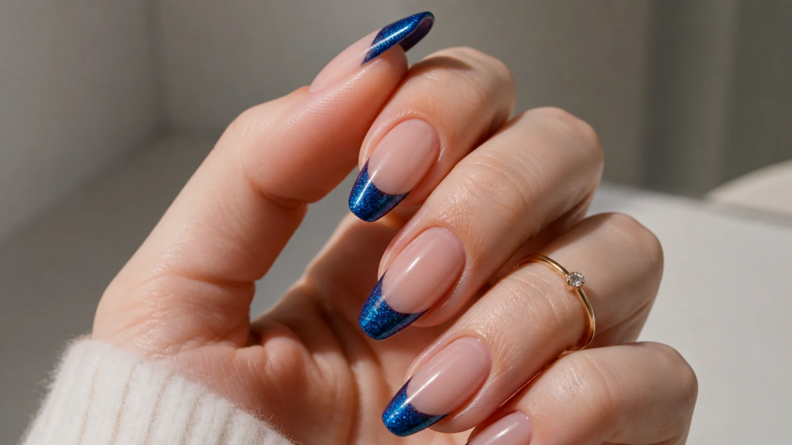 Almond nails with a deep blue magnetic cat eye french tip