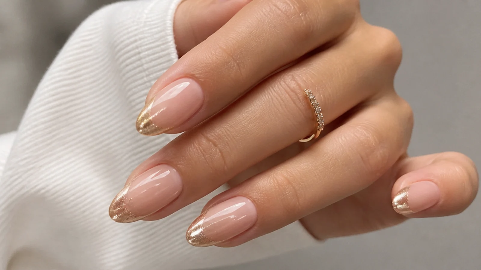 Almond nails with a champagne gold chrome magnetic cat eye french tip