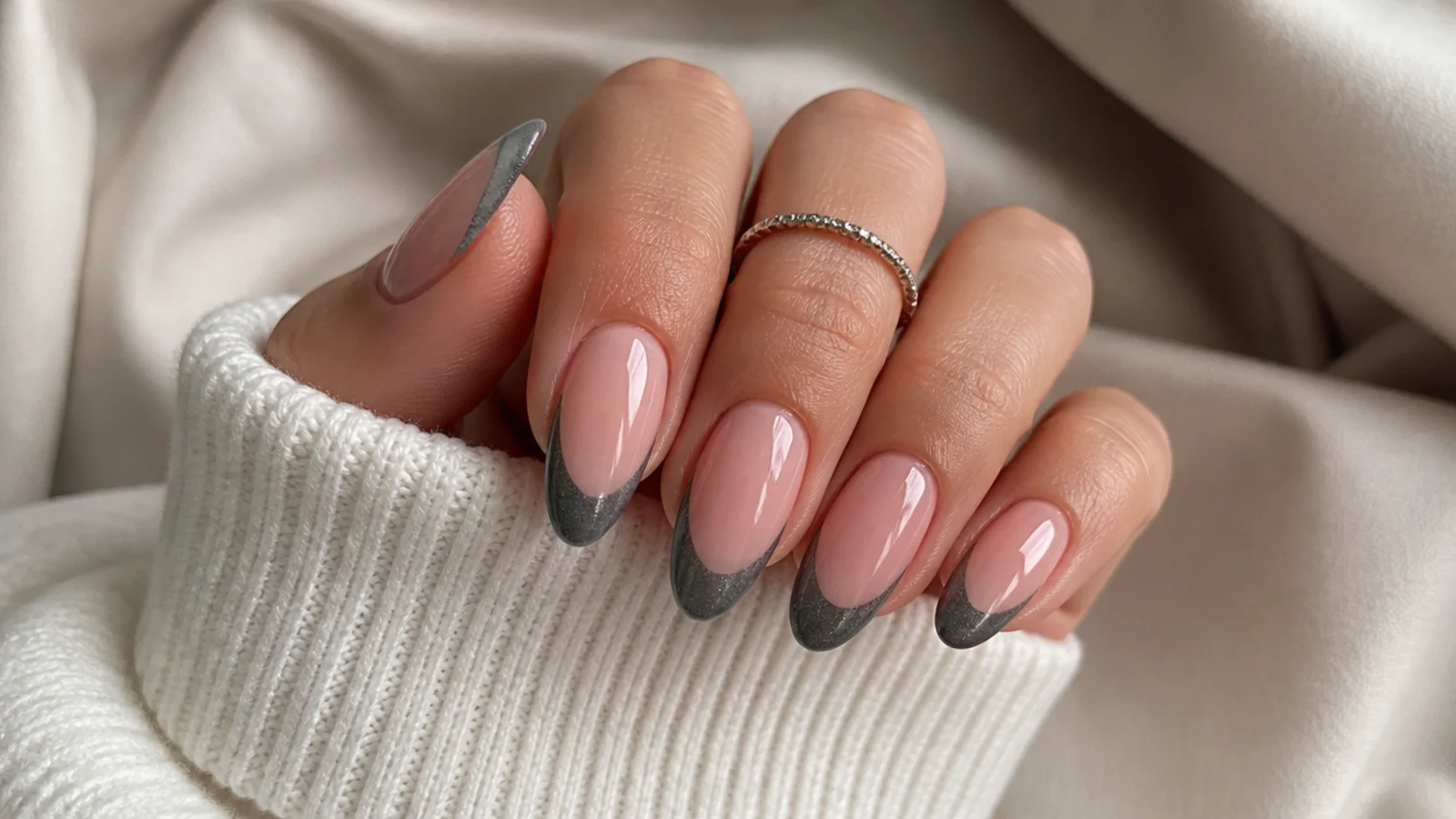 Almond nails with a pewter gray magnetic cat eye french tip