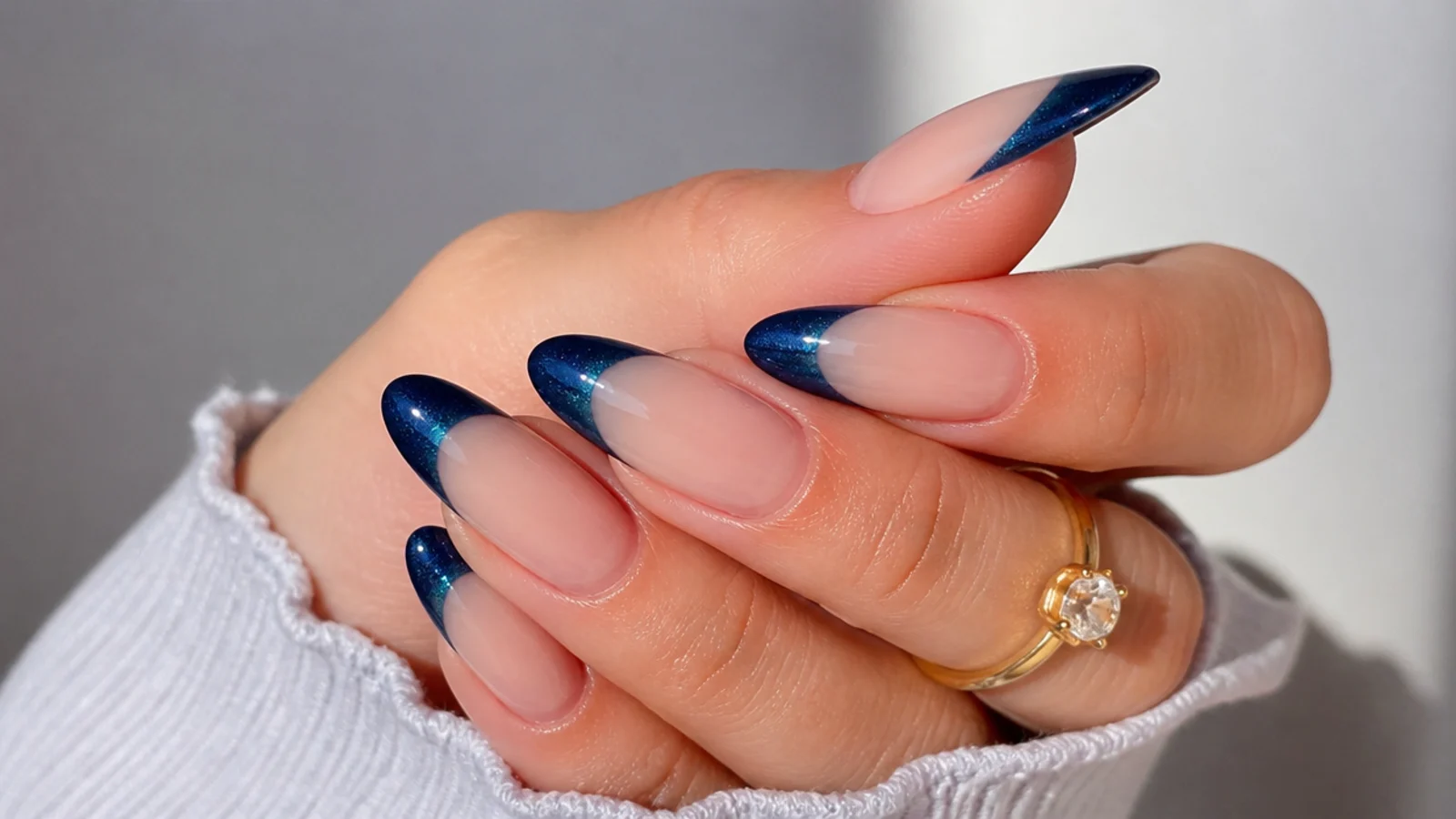 Almond nails with a midnight navy magnetic cat eye french tip